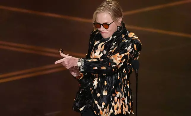 Amy Madigan accepts the award for actress in a supporting role for "Weapons" during the Oscars on Sunday, March 15, 2026, at the Dolby Theatre in Los Angeles. (AP Photo/Chris Pizzello)
