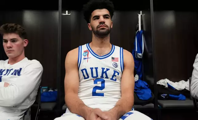 Duke guard Cayden Boozer sits in the locker room after their Elite Eight game of the NCAA college basketball tournament against UConn, Sunday, March 29, 2026, in Washington. (AP Photo/Stephanie Scarbrough)