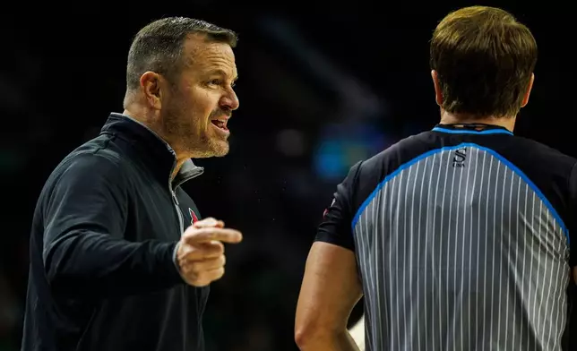 FILE - Louisville head coach Jeff Walz, left, disagrees with a call during the first half of an NCAA college basketball game against Notre Dame, March 2, 2025, in South Bend, Ind. (AP Photo/John Mersits, File)