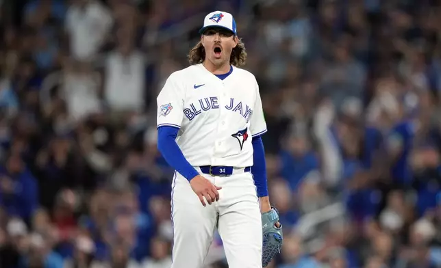 Toronto Blue Jays pitcher Kevin Gausman reacts after throwing a strikeout against the Athletics during first-inning baseball game action in Toronto, Friday, March 27, 2026. (Nathan Denette/The Canadian Press via AP)