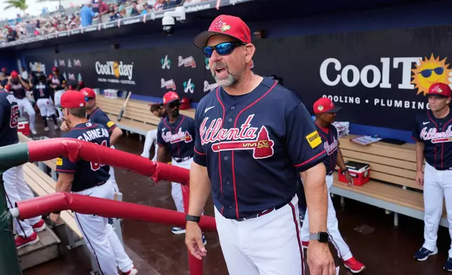 FILE - Atlanta Braves manager Walt Weiss sands in the dugout before a spring training baseball game against the Boston Red Sox in North Port, Fla., Friday, Feb. 27, 2026. (AP Photo/Gerald Herbert,File)