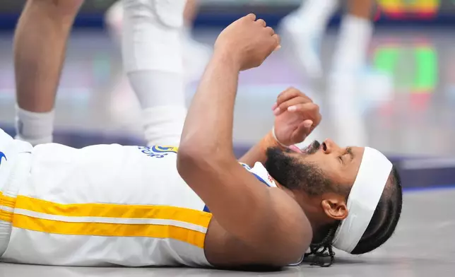 Golden State Warriors guard Moses Moody reacts after being fouled by Dallas Mavericks forward Cooper Flagg during overtime of an NBA basketball game Monday, March 23, 2026, in Dallas. (AP Photo/Julio Cortez)