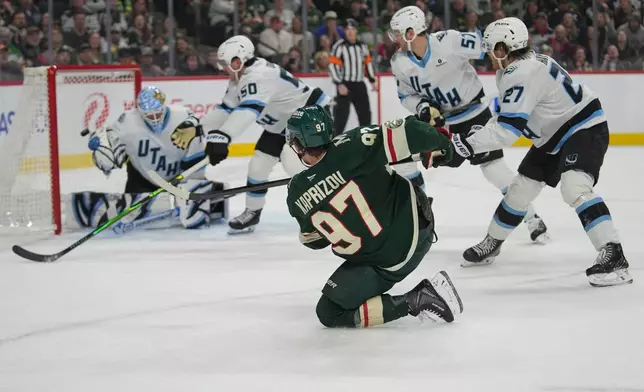 Minnesota Wild left wing Kirill Kaprizov (97) shoots and scores a goal past Utah Mammoth goaltender Karel Vejmelka (70) during the first period of an NHL hockey game, Tuesday, March 10, 2026, in St. Paul, Minn. (AP Photo/Abbie Parr)