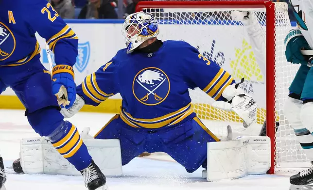 Buffalo Sabres goaltender Alex Lyon (34) slides across the crease to make a save during the second period of an NHL hockey game against the San Jose Sharks Tuesday, March 10, 2026, in Buffalo, N.Y. (AP Photo/Jeffrey T. Barnes)