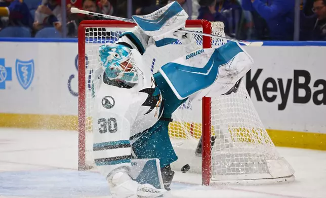 San Jose Sharks goaltender Yaroslav Askarov (30) slides across the crease as the puck goes in on a shot by Buffalo Sabres right wing Jack Quinn during the first period of an NHL hockey game Tuesday, March 10, 2026, in Buffalo, N.Y. (AP Photo/Jeffrey T. Barnes)