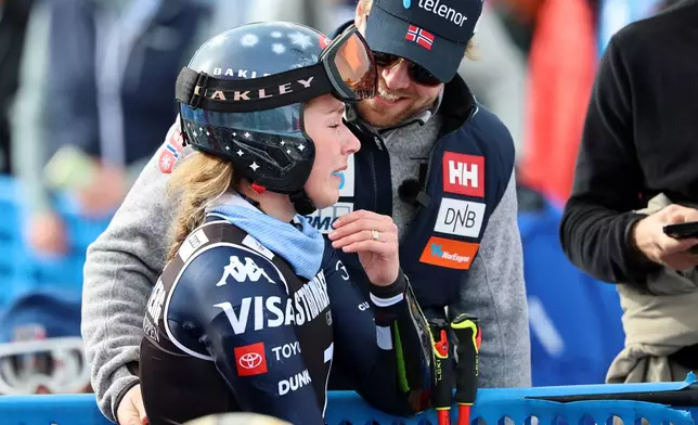United States' Mikaela Shiffrin is overcome with emotion as her fiancee Norway's Aleksander Aamodt Kilde stands by her side, at the finish area of an alpine ski, women's giant slalom race, at the Lillehammer World Cup Finals, in Hafjell, Norway, Wednesday, March 25, 2026. (AP Photo/Marco Trovati)