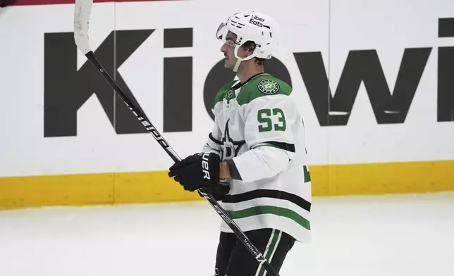 Dallas Stars center Wyatt Johnston reacts after scoring the winning goal during a shootout in an NHL hockey game against the Colorado Avalanche, Wednesday, March 18, 2026, in Denver. (AP Photo/David Zalubowski)