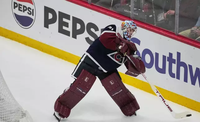 Colorado Avalanche goaltender Scott Wedgewood clears the puck in the first period of an NHL hockey game against the Dallas Stars, Wednesday, March 18, 2026, in Denver. (AP Photo/David Zalubowski)