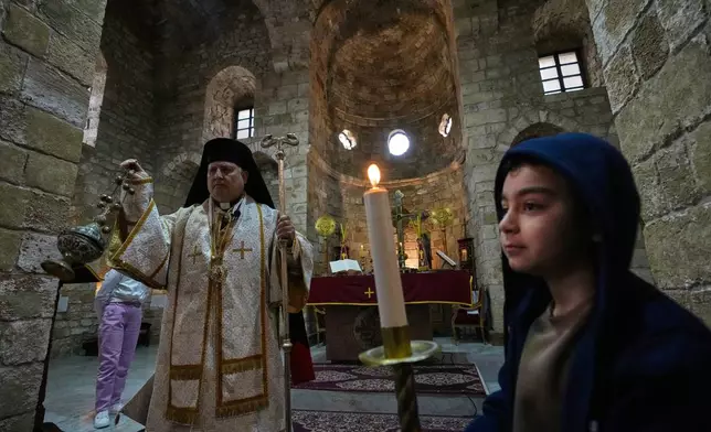 George Iskandar, the Metropolitan Archbishop of Tyre for the Melkite Greek Catholic Church presides over a Palm Sunday Mass at Saint Thomas Cathedral, in the southern port city of Tyre, south Lebanon, Sunday, March 29, 2026. (AP Photo/Hussein Malla)