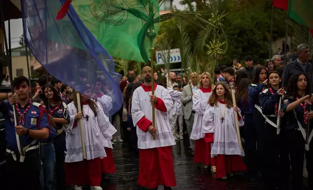Worshipers walk in a procession during a Palm Sunday Mass at the Our Lady of Hadat Church in Beirut, Lebanon, Sunday, March 29, 2026. (AP Photo/Emilio Morenatti)