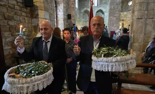 Worshipers attend Palm Sunday Mass procession at Saint Thomas Cathedral, in the southern port city of Tyre, south Lebanon, Sunday, March 29, 2026. (AP Photo/Hussein Malla)