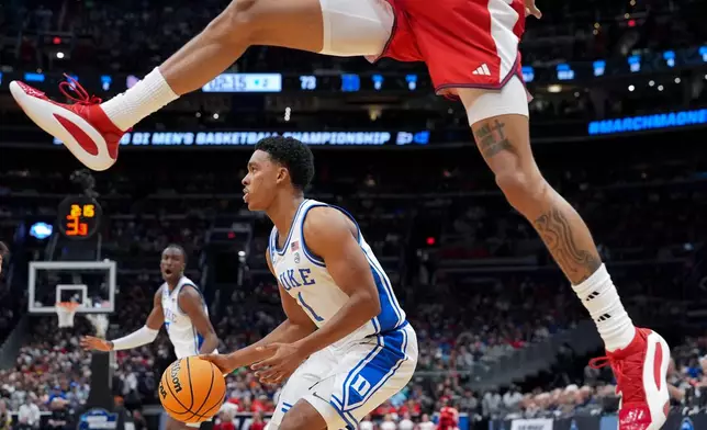 Duke guard Caleb Foster (1) looks to pass against St. John's during the second half in the Sweet 16 of the NCAA college basketball tournament, Friday, March 27, 2026, in Washington. (AP Photo/Stephanie Scarbrough)