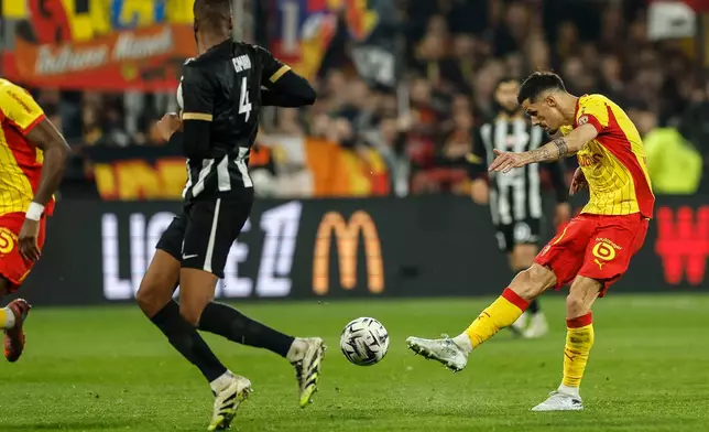 Lens' Sotoca Florian shoots at goal during the French League One soccer game between Lens and Angers, Friday, March 20,2 026, in Lens, France. (AP Photo/Jean-Francois Badias)