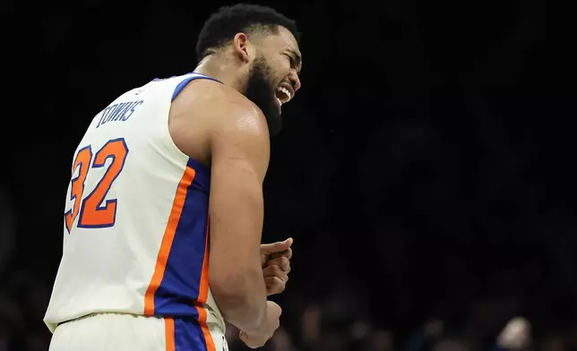 New York Knicks center Karl-Anthony Towns (32) reacts during the second half of an NBA basketball game against the Brooklyn Nets, Friday, March 20, 2026, in New York. (AP Photo/Heather Khalifa)