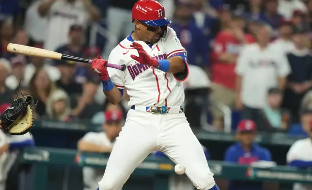 Dominican Republic Julio Rodríguez is hit by a pitch during the fourth inning of a World Baseball Classic semifinal game against the United States, Sunday, March 15, 2026, in Miami. (AP Photo/Lynne Sladky)