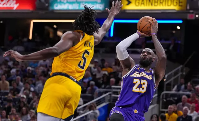 Los Angeles Lakers forward LeBron James (23) shoots over Indiana Pacers forward Jarace Walker (5) during the second half of an NBA basketball game in Indianapolis, Wednesday, March 25, 2026. (AP Photo/Michael Conroy)