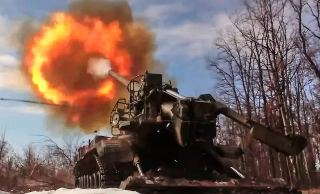 In this image made from video provided by Russian Defense Ministry Press Service on Monday, March 23, 2026, a Russian Pion self-propelled 203 mm cannon fires towards a Ukrainian position. (Russian Defense Ministry Press Service via AP)