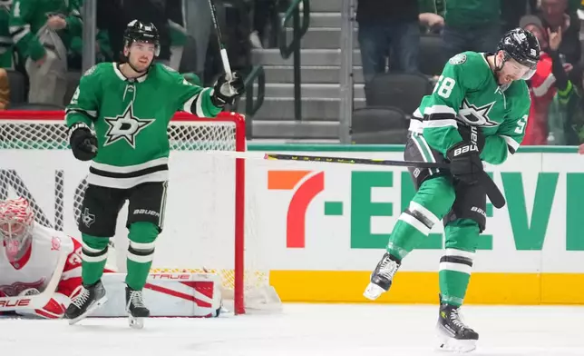 Dallas Stars left wing Michael Bunting, right, reacts after scoring his first career goal with the Stars during the second period of an NHL hockey game against the Detroit Red Wings Saturday, March 14, 2026, in Dallas. (AP Photo/Julio Cortez)