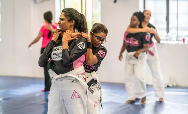 Female students train in self-defense techniques at the Gracie Jiu-jitsu Martial Arts school in Fourways, Johannesburg, Saturday, Jan. 31, 2026. (AP Photo/Jacques Nelles)