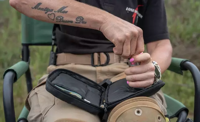 A female student reloads her magazine after a round of shooting at the Out There Sport Shooting Range in Bronkhorstspruit, Pretoria, South Africa, Saturday, Jan. 24, 2026. (AP Photo/Jacques Nelles)