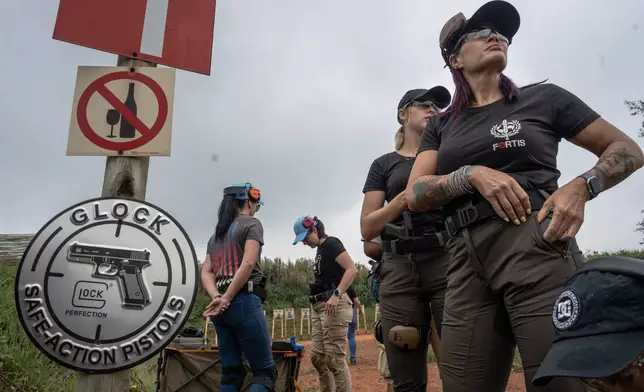 A women only group prepares for training at the Out There Sport Shooting Range in Bronkhorstspruit, Pretoria, South Africa, Saturday, Jan. 24, 2026. (AP Photo/Jacques Nelles)
