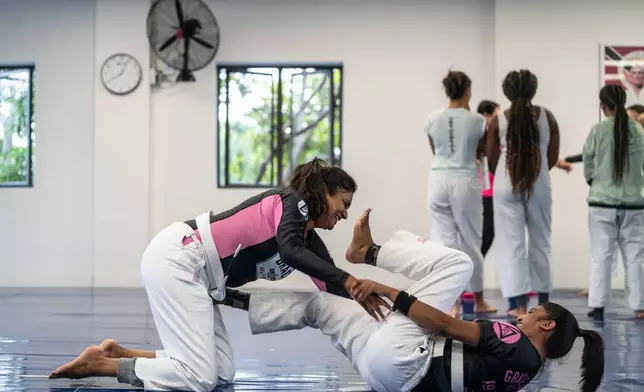 Female students train in self-defense techniques at the Gracie Jiu-jitsu Martial Arts school in Fourways, Johannesburg, Saturday, Jan. 31, 2026. (AP Photo/Jacques Nelles)