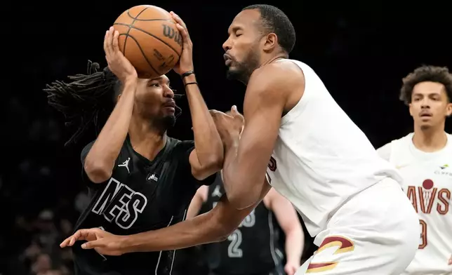 Brooklyn Nets forward Ziaire Williams (1) drives past Cleveland Cavaliers center Evan Mobley during the first half of an NBA basketball game, Sunday, March 1, 2026, in New York. (AP Photo/Yuki Iwamura)