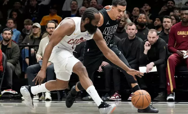 Cleveland Cavaliers guard James Harden (1) fights for control of the ball with Brooklyn Nets forward Michael Porter Jr. (17) during the first half of an NBA basketball game, Sunday, March 1, 2026, in New York. (AP Photo/Yuki Iwamura)