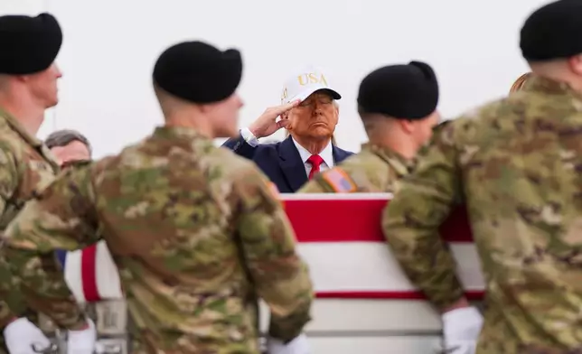 President Donald Trump salutes as an Army carry team moves a flag-draped transfer case with the remains of Sgt. Declan Coady, 20, of West Des Moines, Iowa, who was killed in a drone strike at a command center in Kuwait after the U.S. and Israel launched its military campaign against Iran, during a casualty return, Saturday, March 7, 2026, at Dover Air Force Base, Del. (AP Photo/Julia Demaree Nikhinson)