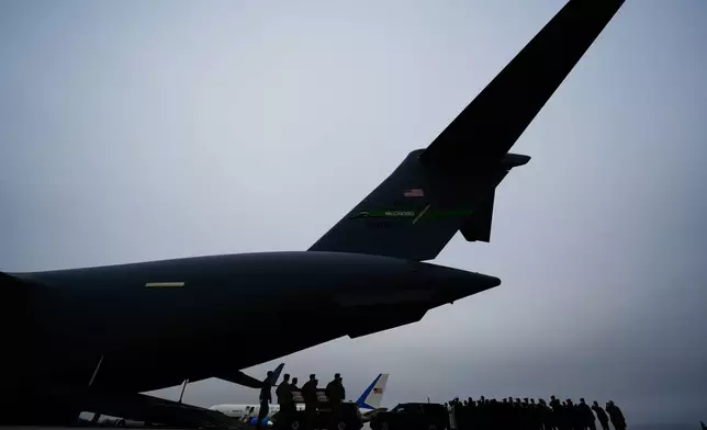 An Army carry team moves a flag-draped transfer case containing the remains of a soldier who was killed in a drone strike at a command center in Kuwait after the U.S. and Israel launched its military campaign against Iran, during a casualty return Saturday, March 7, 2026, at Dover Air Force Base, Del. (AP Photo/Julia Demaree Nikhinson)