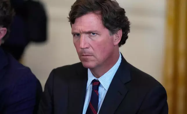 FILE - Tucker Carlson attends a meeting with President Donald Trump and oil executives in the East Room of the White House, Friday, Jan. 9, 2026, in Washington. (AP Photo/Alex Brandon)