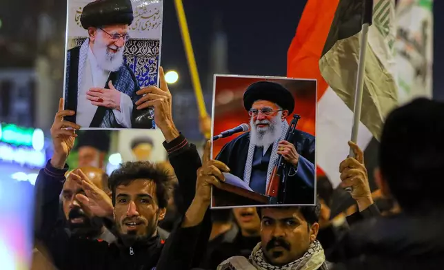 Iraqi Shiites hold pictures of Iranian Supreme Leader Ayatollah Ali Khamenei, who was killed by a U.S. airstrike in Tehran, during a symbolic funeral, in Najaf, Iraq, Sunday, March 1, 2026. (AP Photo/Anmar Khalil)