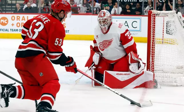 Carolina Hurricanes' Jackson Blake (53) controls the puck saw he approaches Detroit Red Wings goaltender Cam Talbot (39) during the second period of an NHL hockey game in Raleigh, N.C., Saturday, Feb. 28, 2026. (AP Photo/Karl DeBlaker)