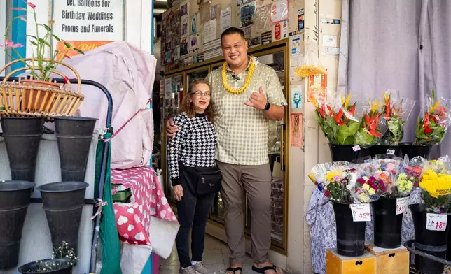 Mei Mei Say, owner of M.P. Lei Shop, left, poses for a photo with State Rep. Darius Kila, D-Nanakuli, in Chinatown, Thursday, Feb. 26, 2026, in Honolulu. (AP Photo/Mengshin Lin)