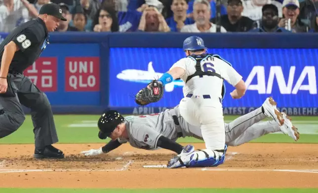 Arizona Diamondbacks' Pavin Smith, center, is tagged out by Los Angeles Dodgers catcher Will Smith as he tries to score on a double by Alek Thomas during the second inning of a baseball game Friday, March 27, 2026, in Los Angeles. (AP Photo/Mark J. Terrill)