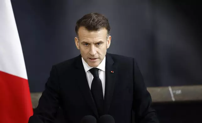 French President Emmanuel Macron delivers a speech next to the submarine 'Le Temeraire' (The Temerarious) at the Nuclear submarines Navy base of Ile Longue in Crozon, France, Monday March 2, 2026. (Yoan Valat/Pool Photo via AP)