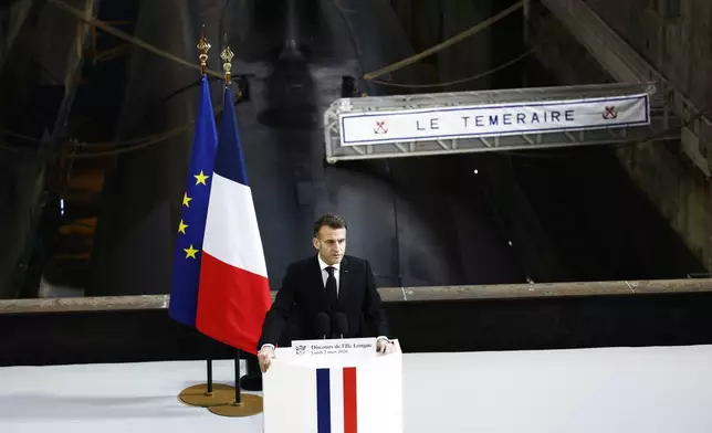 French President Emmanuel Macron delivers a speech next to the submarine 'Le Temeraire' (The Temerarious) at the Nuclear submarines Navy base of Ile Longue in Crozon, France, Monday March 2, 2026. (Yoan Valat/Pool Photo via AP)