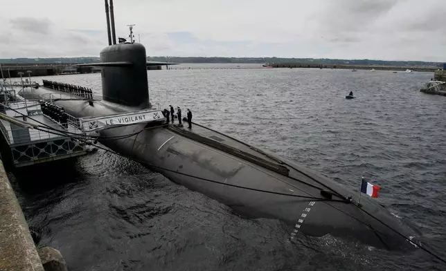 FILE - French Marine officers wait atop "Le Vigilant" nuclear submarine at L'Ile Longue military base, near Brest, Brittany, July 13, 2007. (AP Photo/Francois Mori, Pool, File)