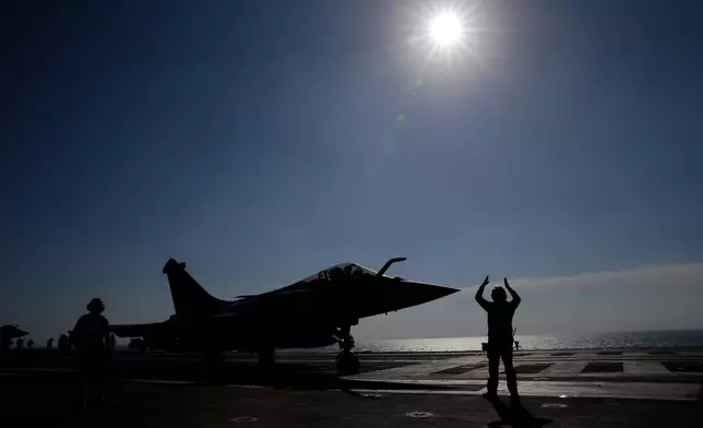 FILE - A Rafale M single seater fighter jet is catapulted on France's flagship Charles de Gaulle aircraft carrier in the Persian Gulf, Jan. 12, 2016. (AP Photo/Christophe Ena, File)