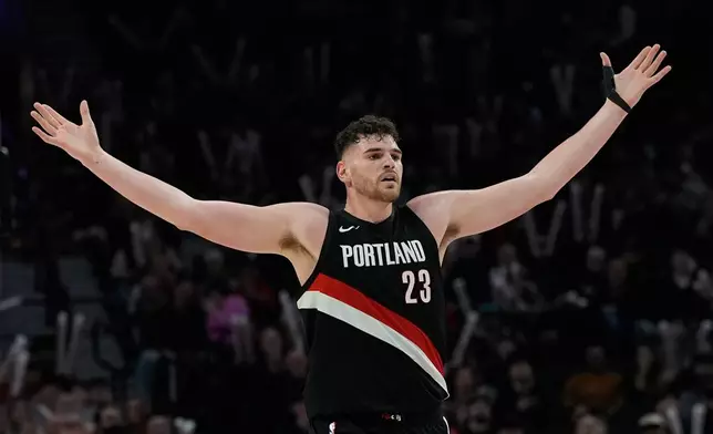 Portland Trail Blazers center Donovan Clingan reacts after the Portland Trail Blazers' scored during the first half of an NBA basketball game against the Utah Jazz, Friday, March 13, 2026, in Portland, Ore. (AP Photo/Jenny Kane)