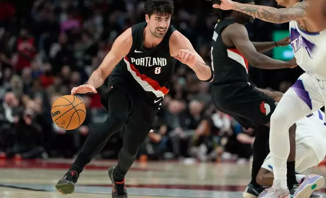 Portland Trail Blazers forward Deni Avdija (8) drives to the basket during the first half of an NBA basketball game against the Utah Jazz, Friday, March 13, 2026, in Portland, Ore. (AP Photo/Jenny Kane)