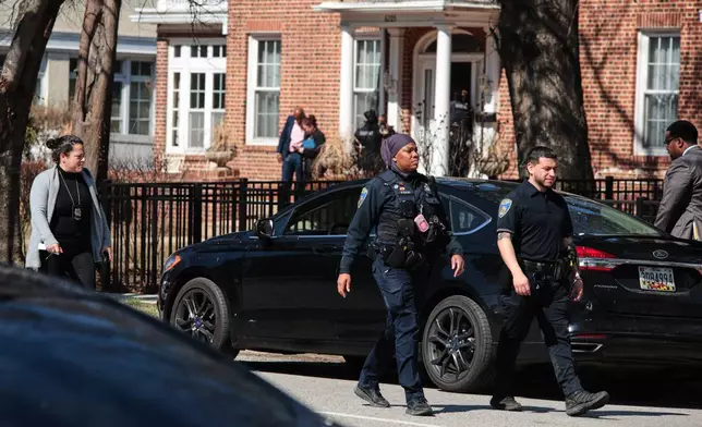 Baltimore Police officers are seen near the scene of a shooting Tuesday, March 10, 2026, in Baltimore. (AP Photo/KT Kanazawich)