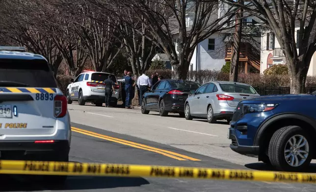 Investigators are seen near the scene of a shooting Tuesday, March 10, 2026, in Baltimore. (AP Photo/KT Kanazawich)