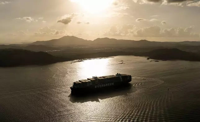 A cargo ship transits the Panama Canal in Panama City, Thursday, March 12, 2026. (AP Photo/Matias Delacroix)