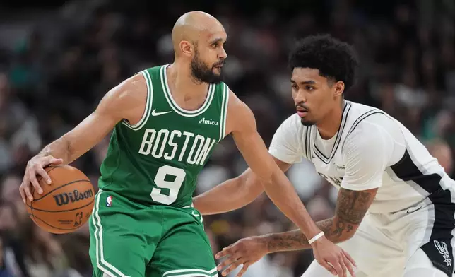 Boston Celtics guard Derrick White (9) works the ball against San Antonio Spurs guard Dylan Harper (2) during the second half of an NBA basketball game in San Antonio, Tuesday, March 10, 2026. (AP Photo/Eric Gay)
