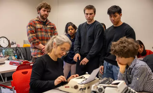 Grit Matthias Phelps gives students a demonstration on how to use a typewriter before class at Cornell University, Friday, March 20, 2026, in Ithaca, N.Y. (AP Photo/Lauren Petracca)