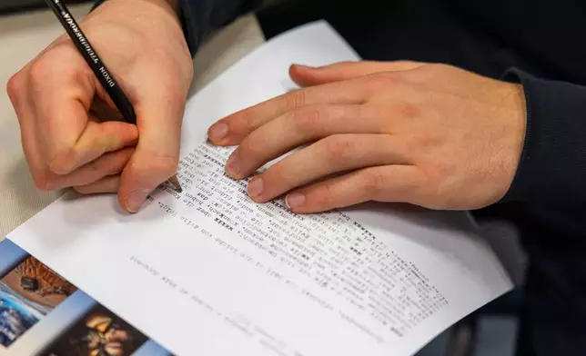 Marcello Popelka makes edits using a pencil after writing an assignment in German on a typewriter at Cornell University, Friday, March 20, 2026, in Ithaca, N.Y. The professor, Grit Matthias Phelps, brings out the typewriters once each semester for students to disconnect from technology and connect with the assignment in a different way. (AP Photo/Lauren Petracca)