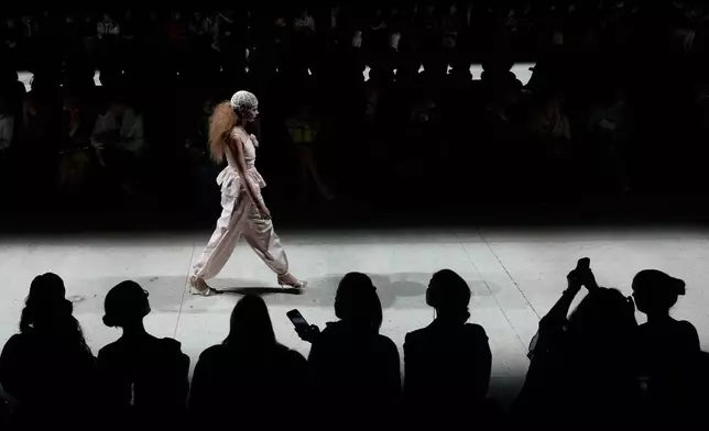 A model wears a creation by Russian brand Masterpeace on a runway at the Moscow Fashion Week in Moscow, Saturday, March 14, 2026. (AP Photo/Pavel Bednyakov)
