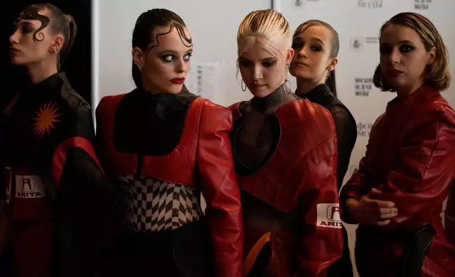 Models are prepared for a runway show at the backstage of the Moscow Fashion Week in Moscow, Saturday, March 14, 2026. (AP Photo/Pavel Bednyakov)