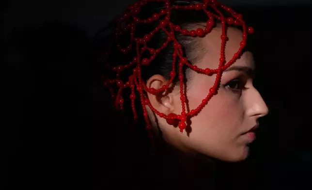A model is prepared for a runway show at the backstage of the Moscow Fashion Week in Moscow, Saturday, March 14, 2026. (AP Photo/Pavel Bednyakov)